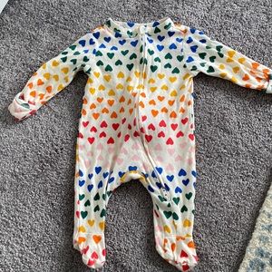 EUC - only worn a few times 0-3 month old navy footie. Rainbow hearts